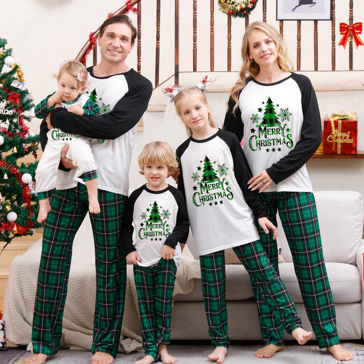 Family Matching Christmas PJs in white tree