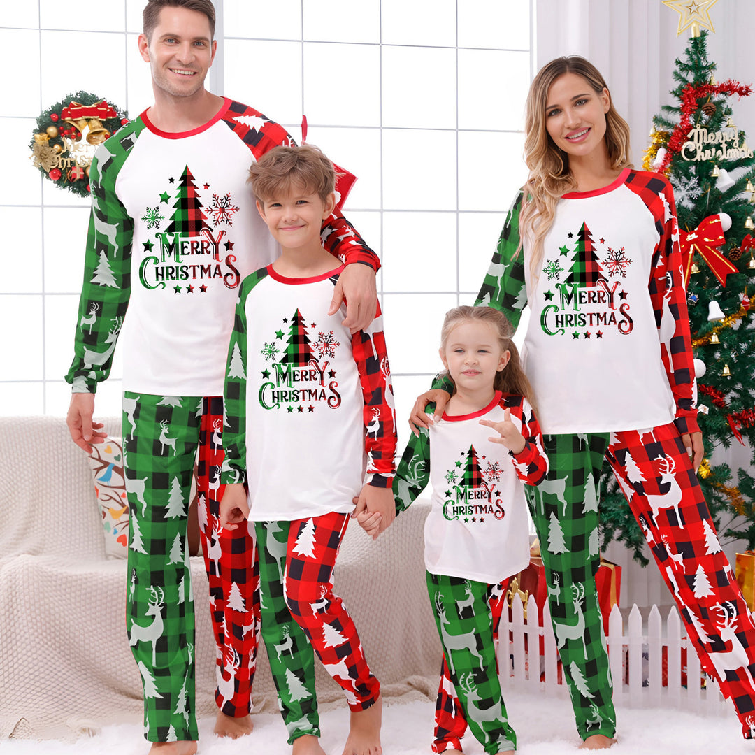 Family Matching Christmas PJs in red tree