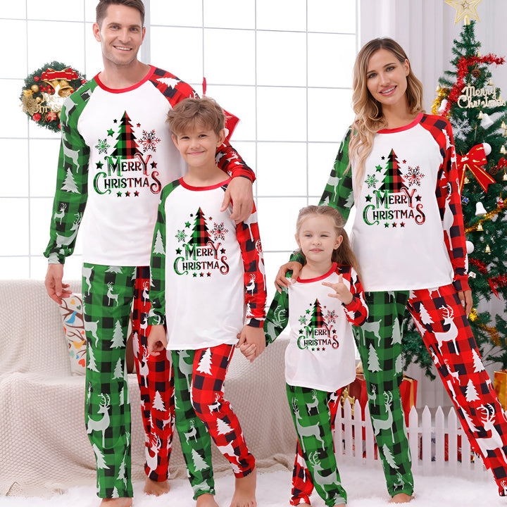 Family Matching Christmas PJs in red tree